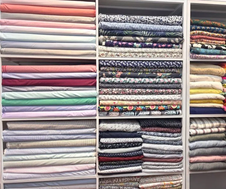 Fabric selection on shelves at the Le Loi atelier