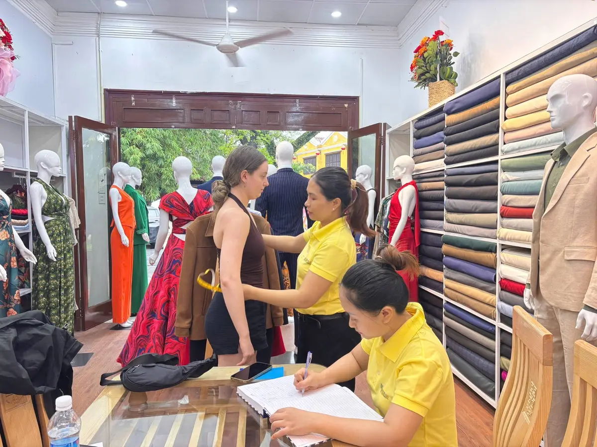 A Bao An Tailor fitting in progress at the Le Loi atelier